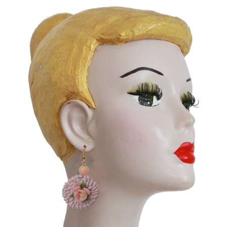 Head with pink rattan earrings