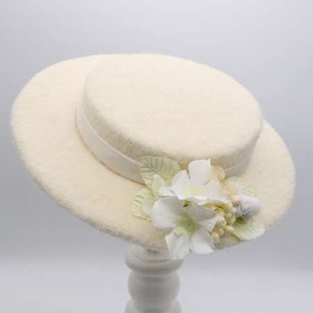Small hat made of wool fabric in ivory
