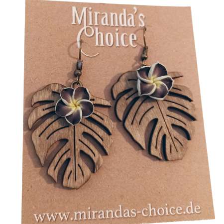 Earrings with dark green frangipani flower on monstera leaf