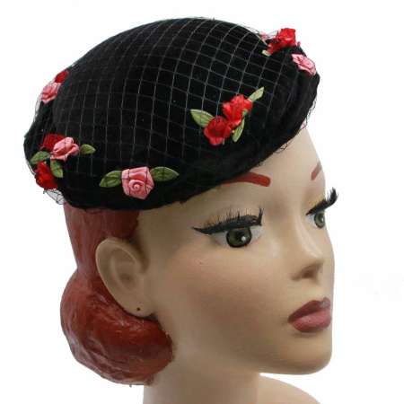 round hat made of velvet in black with small flowers