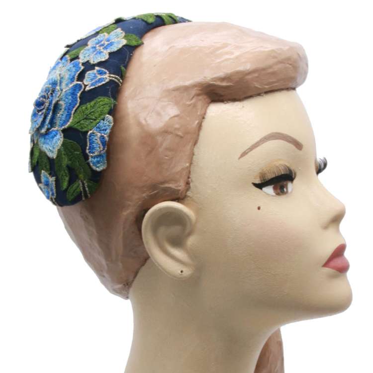 Blue cocktail hat with flower