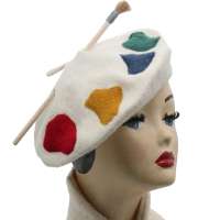 Beige beret with paint and brushes